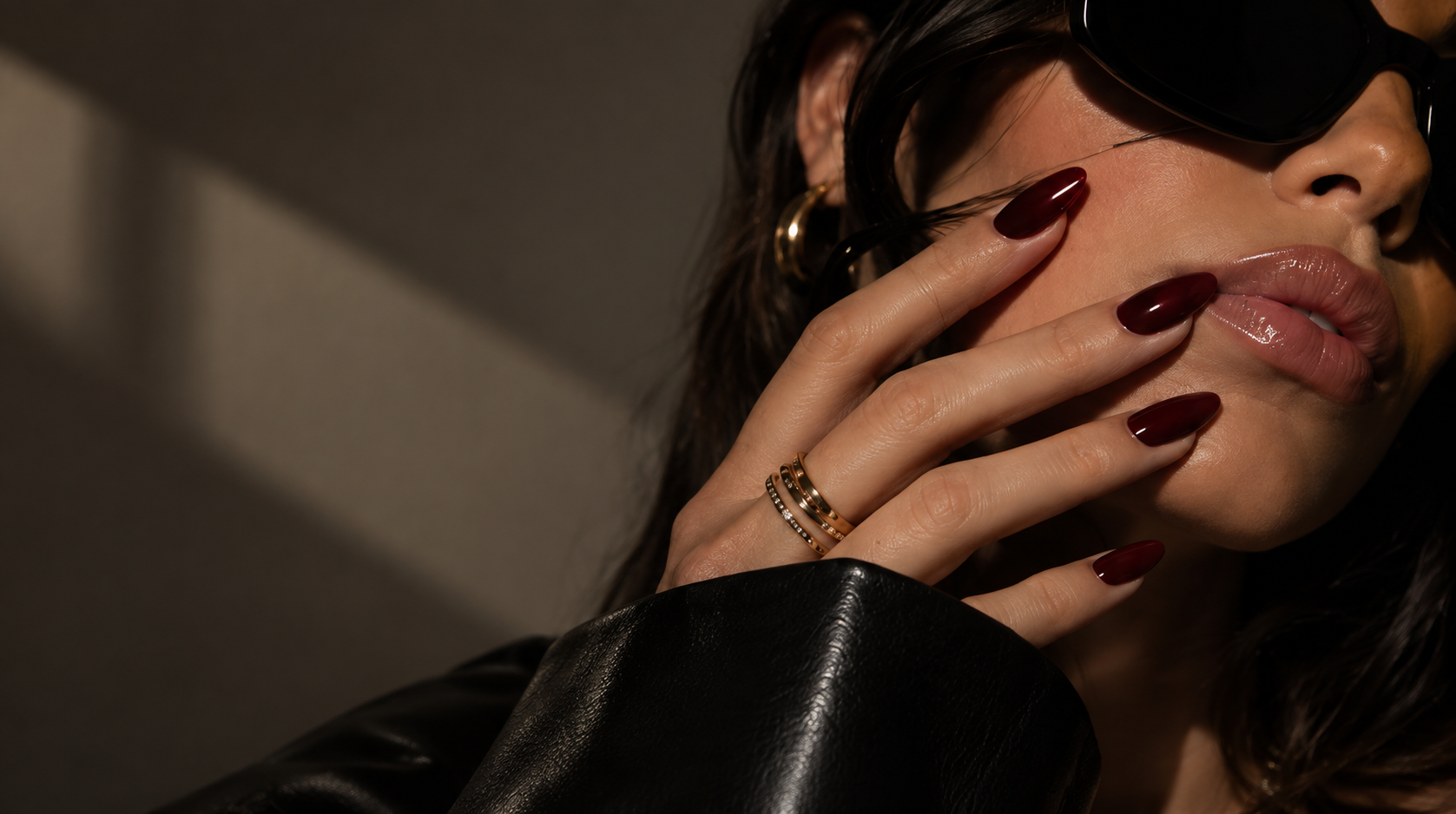 Set Theory campaign: burgundy nails, gold jewelry and a black leather jacket